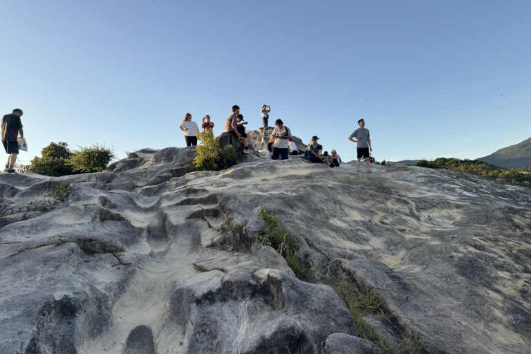 Rock Formation With People At Summit Battleship Rock